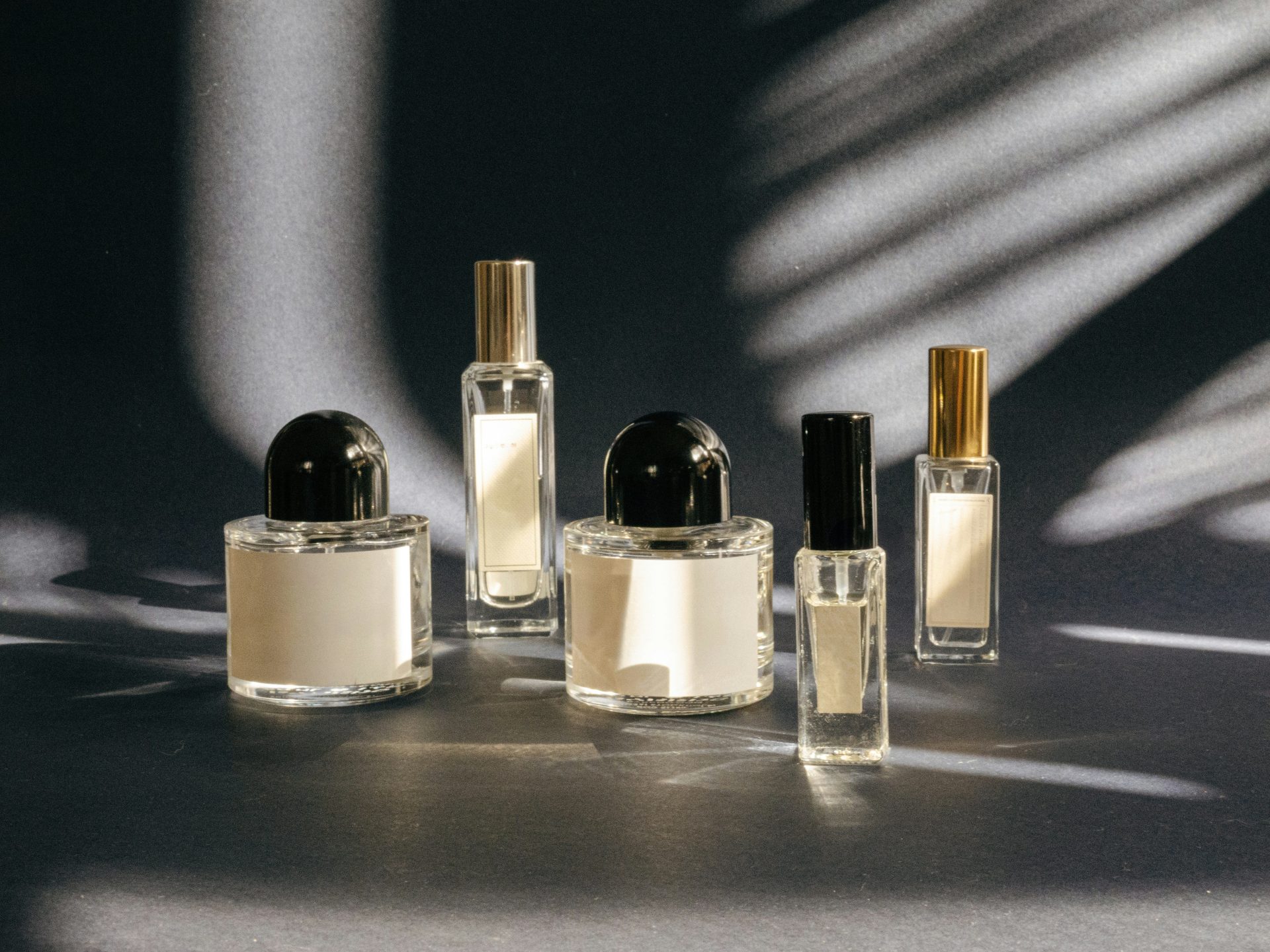 A group of perfume bottles sitting on top of a table